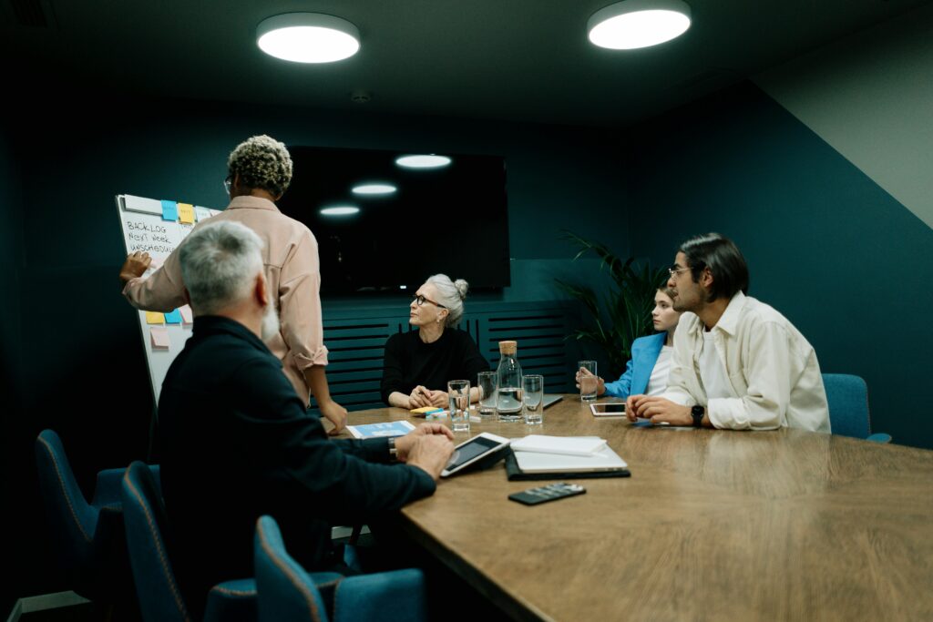 AWS Diverse team discussing business strategy during a meeting in a modern office setting.